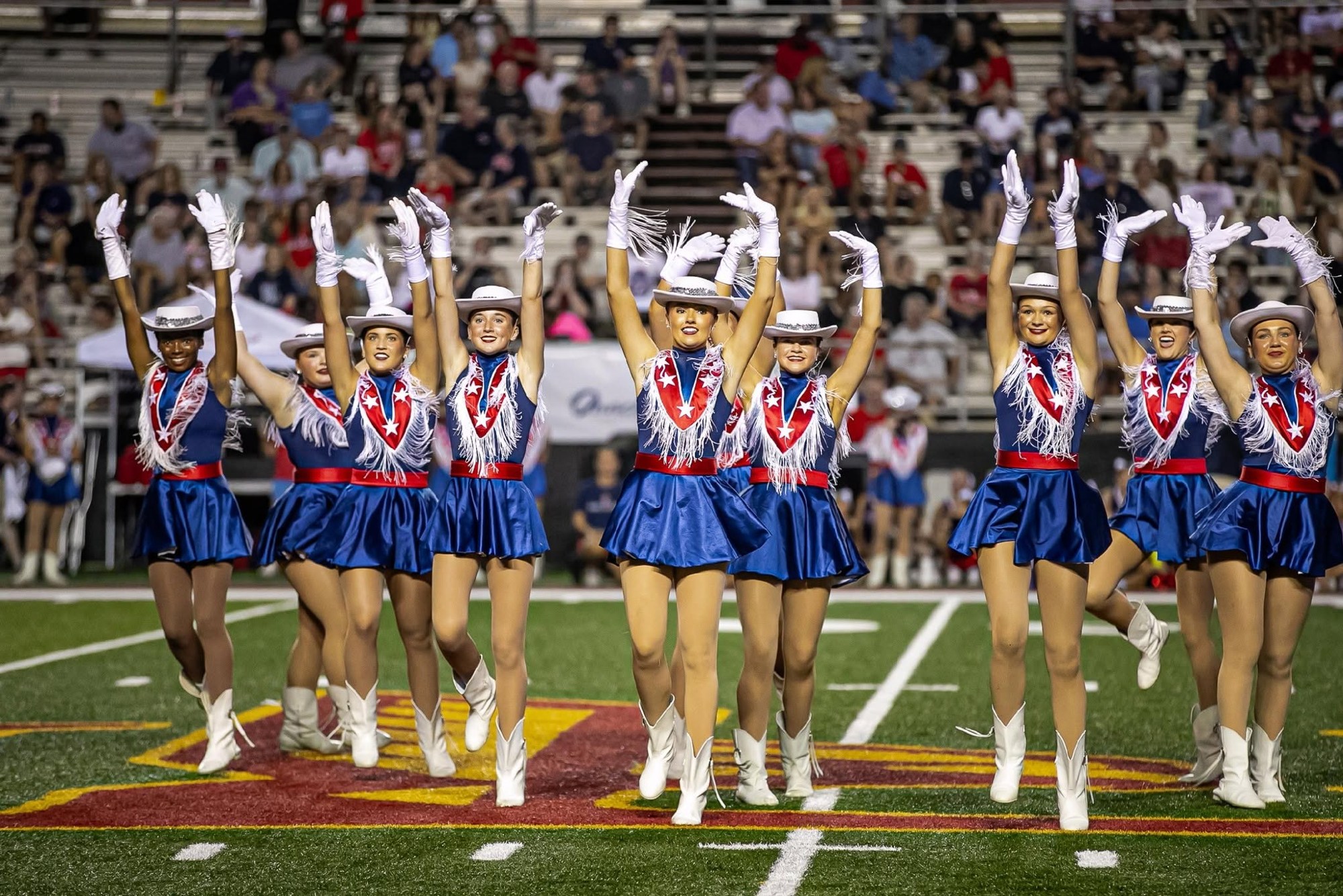 School spirit squad performing on the football field at Bayou Jamb