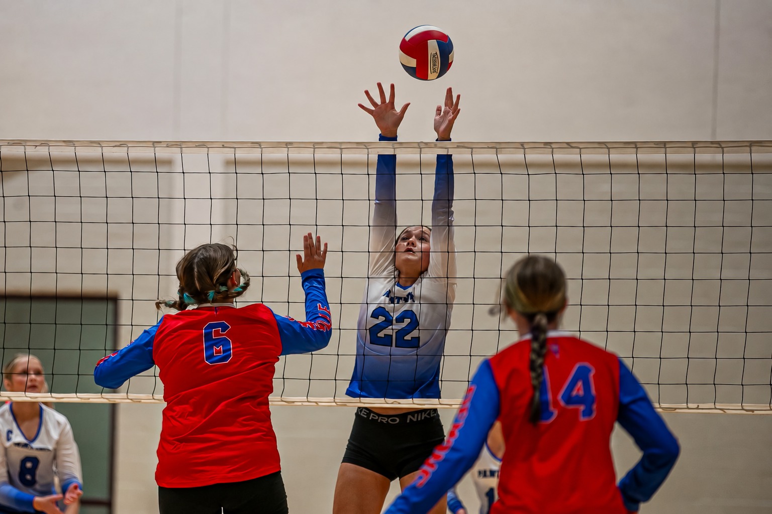 Volleyball players competing at the net at Bayou Jamb